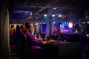 Man at competitive computer gaming station.