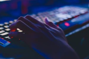 Hand on an e-sports gaming keyboard.