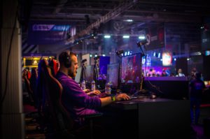 Man at competitive computer gaming station.